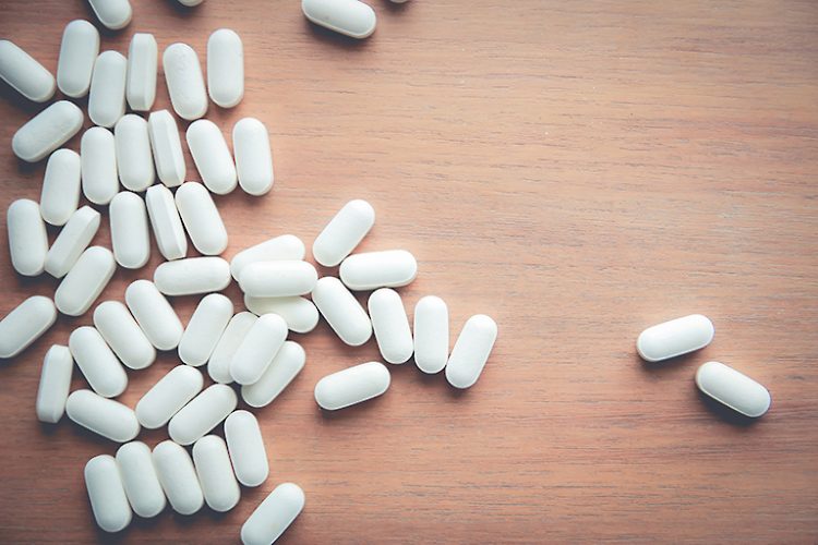 medicine pill on wood table