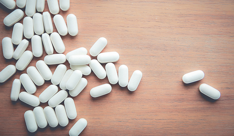 medicine pill on wood table
